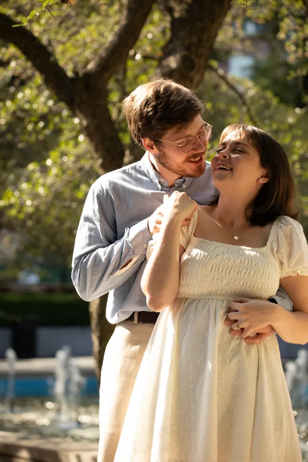 Their faces close together under low branches