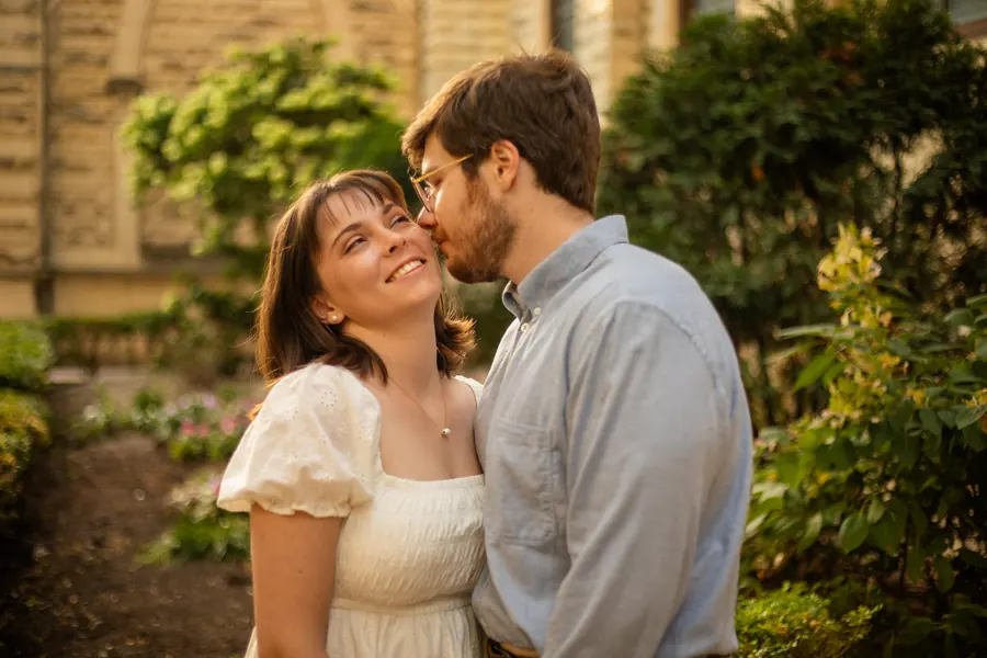 The two of them kissing in a garden