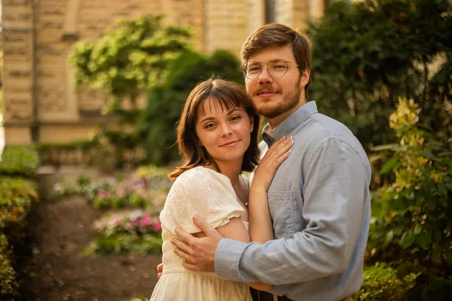 The couple in a garden, both looking toward the camera